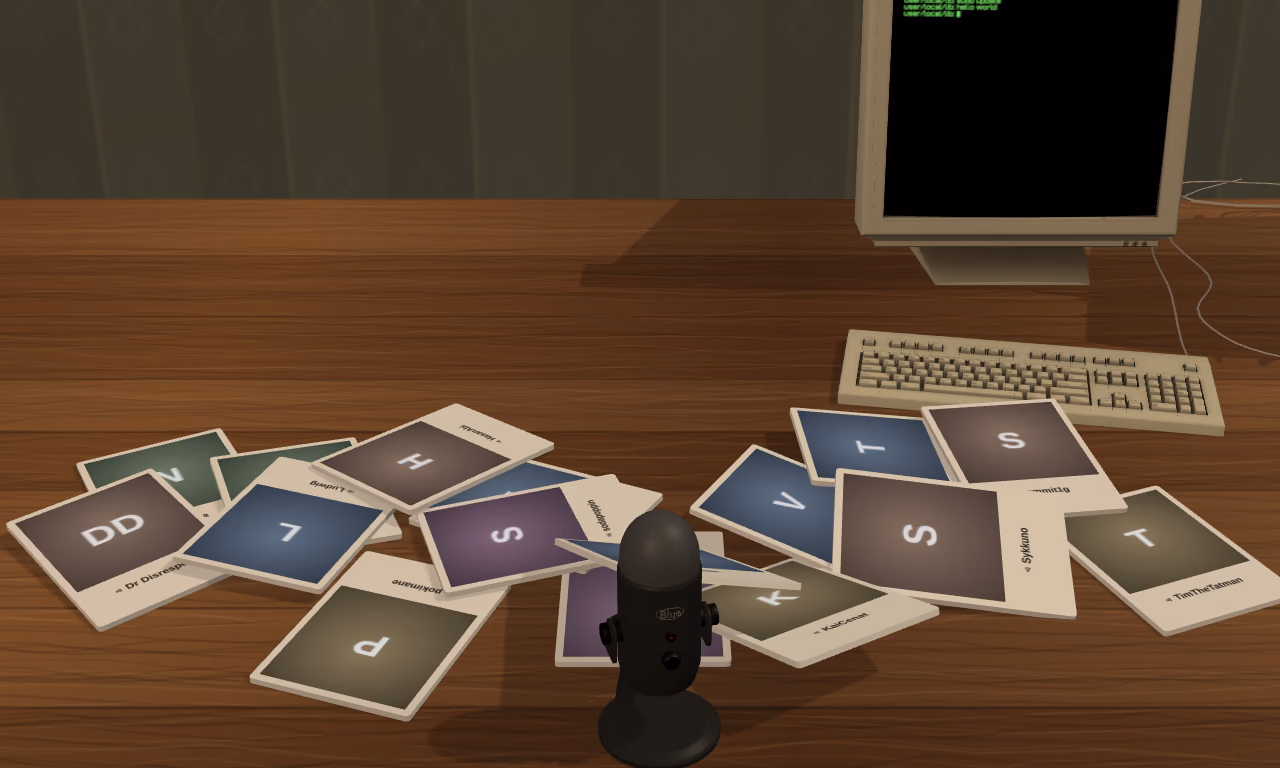 A desk with a microphone, an old computer and a spread of creator cards.